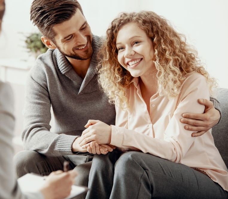 A couple helping their child in family therapy